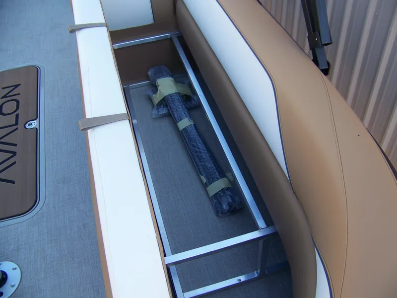 Slide: The Image of 2025 Avalon Ven25VRB boat interior storage compartment with cushioned seating. - 6