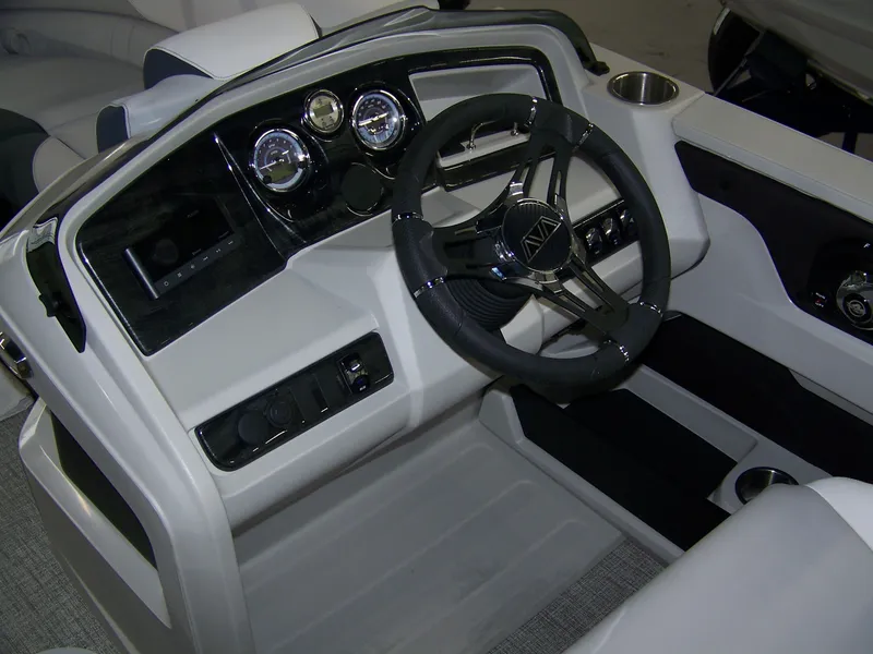 Slide: The Image of 2025 Avalon LSZ23QLS boat dashboard with steering wheel and gauges. - 10