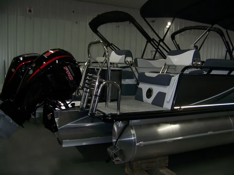 Slide: The Image of 2025 Avalon LSZ23QLS pontoon boat with dual engines and sleek seating design. - 3