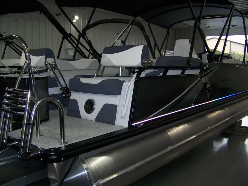 Slide: The Image of 2025 Avalon LSZ23QLS pontoon boat with sleek design and modern seating. - 4