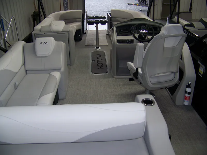 Slide: The Image of 2025 Avalon LSZ25VRB boat interior with plush seating and modern helm. - 9