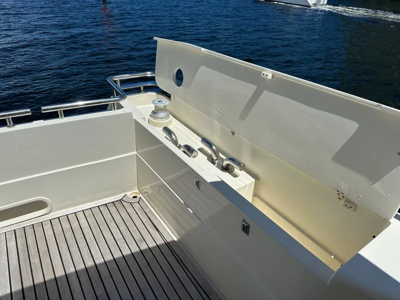 Slide: The Image of 1998 Ferretti Yachts 80 deck with railing and storage, overlooking the water. - 11