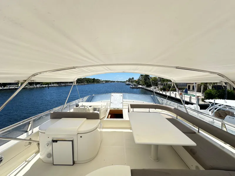 Slide: The Image of Flybridge view of 1998 Ferretti Yachts 80, featuring seating and table under canopy. - 13