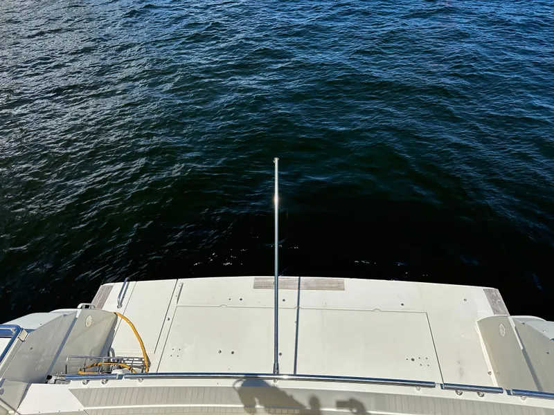 Slide: The Image of 1998 Ferretti Yachts 80 stern view, overlooking calm blue water. - 16