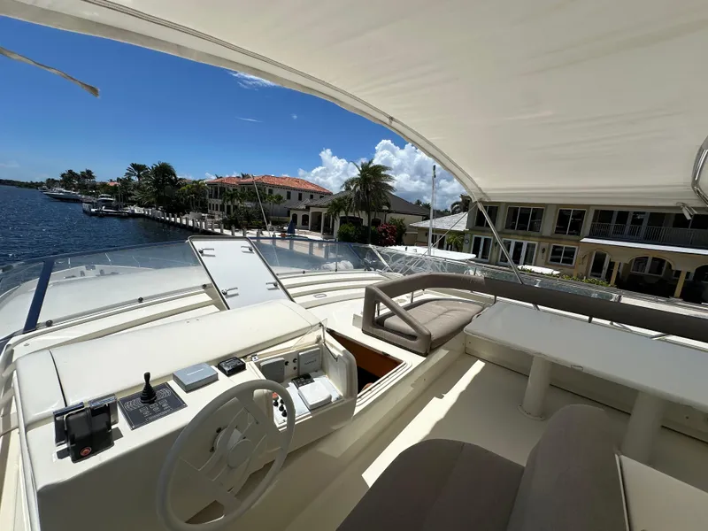 Slide: The Image of Flybridge view of 1998 Ferretti Yachts 80, overlooking waterfront homes and clear blue sky. - 17