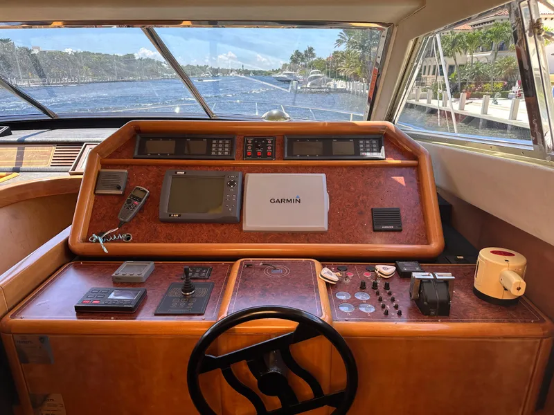 Slide: The Image of Helm of 1998 Ferretti Yachts 80 with navigation equipment and scenic waterway view. - 24