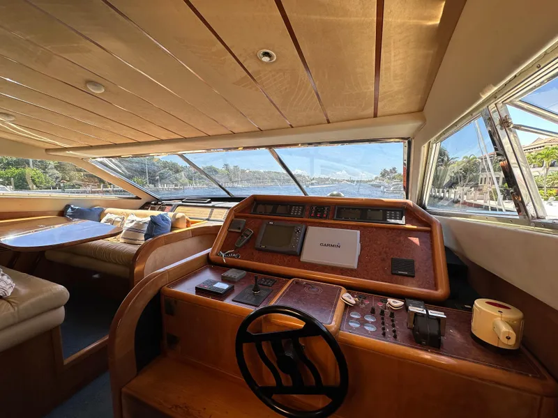 Slide: The Image of Interior view of 1998 Ferretti Yachts 80, featuring helm and seating area with scenic window views. - 25