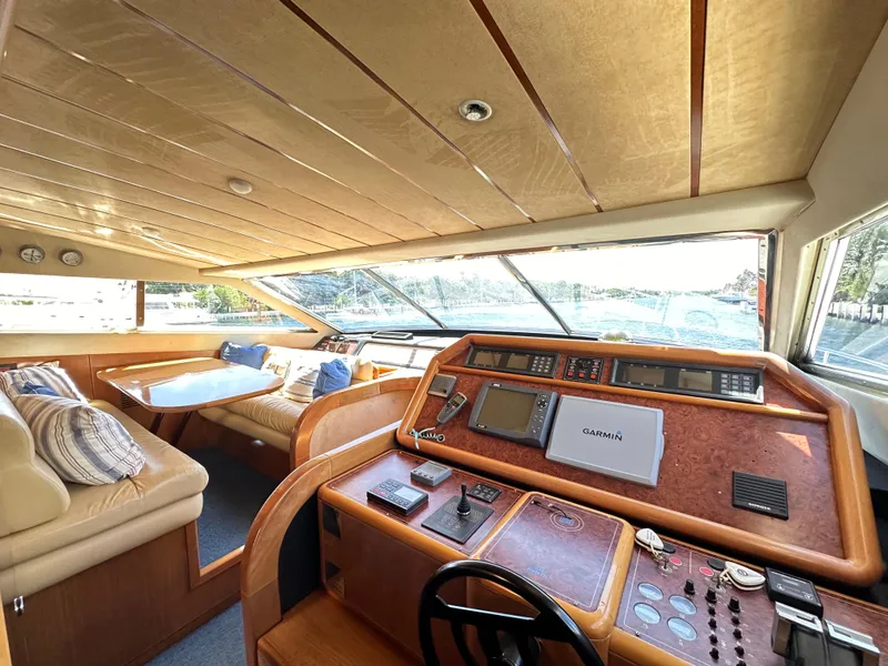 Slide: The Image of Interior of 1998 Ferretti Yachts 80, featuring helm and seating area with panoramic windows. - 26