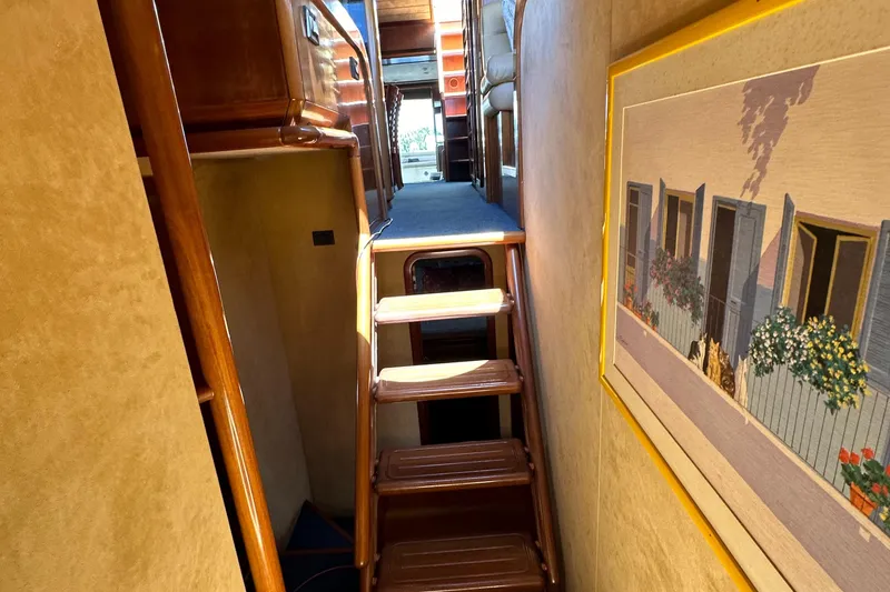 Slide: The Image of Interior of 1998 Ferretti Yachts 80 with wooden stairs and wall art. - 27