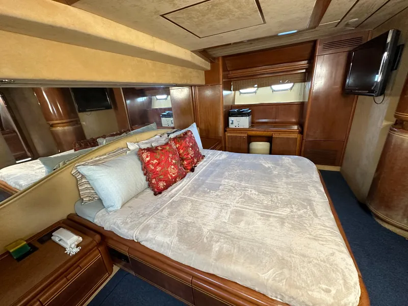 Slide: The Image of Luxurious bedroom interior of a 1998 Ferretti Yachts 80, featuring elegant wood paneling. - 28