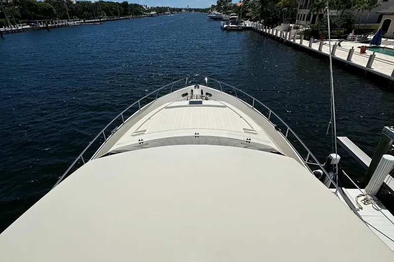 Slide: The Image of Bow view of 1998 Ferretti Yachts 80 on a serene waterway. - 3