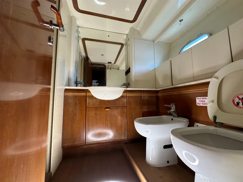 Slide: The Image of Luxurious bathroom in 1998 Ferretti Yachts 80, featuring wood accents and modern fixtures. - 30