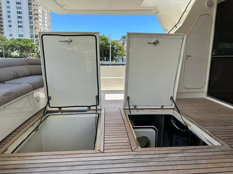 Slide: The Image of Open storage compartments on 1998 Ferretti Yachts 80 deck with wooden flooring. - 36