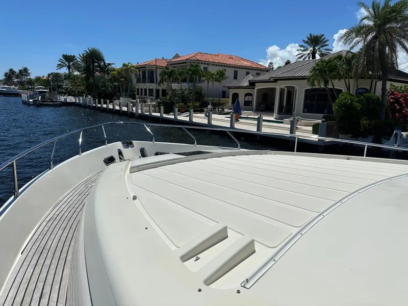 Slide: The Image of 1998 Ferretti Yachts 80 docked by luxurious waterfront homes under clear blue sky. - 5