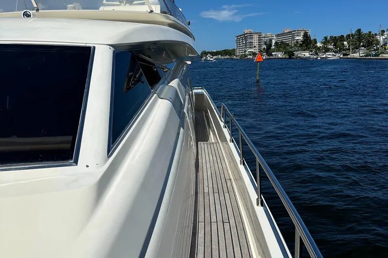 Slide: The Image of 1998 Ferretti Yachts 80 on water, side view, sunny day, coastal buildings in background. - 8