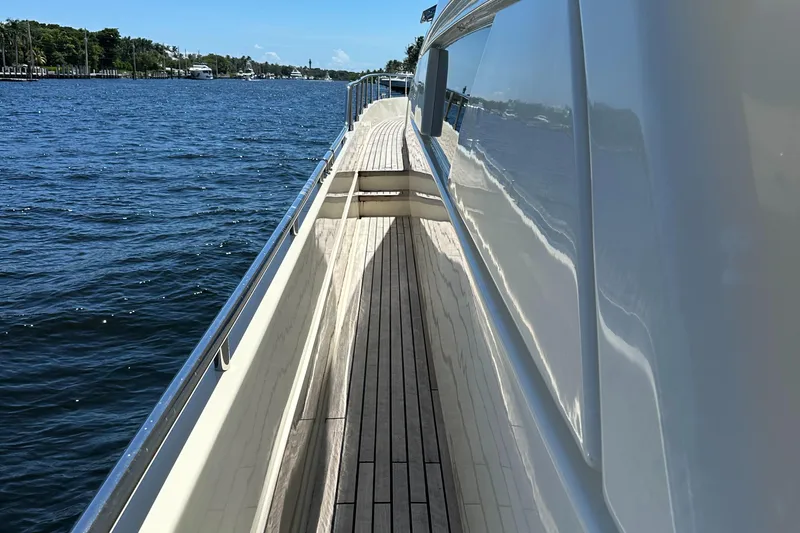 Slide: The Image of Side deck view of 1998 Ferretti Yachts 80, showcasing sleek design and ocean backdrop. - 9