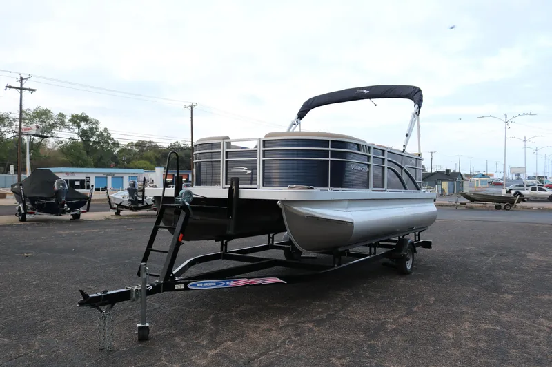 Slide: The Image of 2025 Bennington 20 SSRCX pontoon boat on trailer in parking lot. - 3