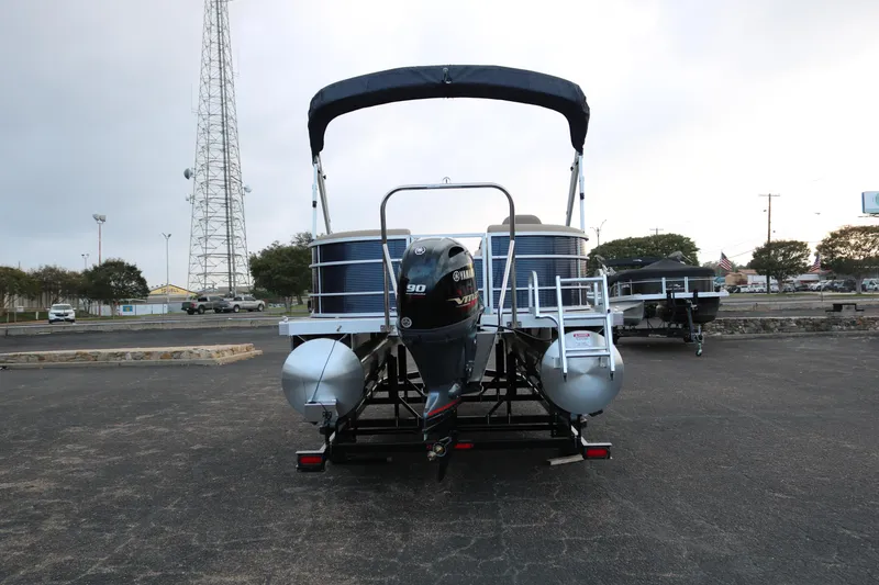 Slide: The Image of 2025 Bennington 20 SSRCX pontoon boat with outboard motor on trailer. - 6