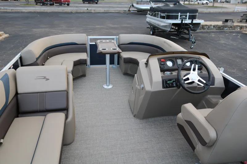 Slide: The Image of 2025 Bennington 20 SSRCX pontoon boat interior with plush seating and modern helm. - 8