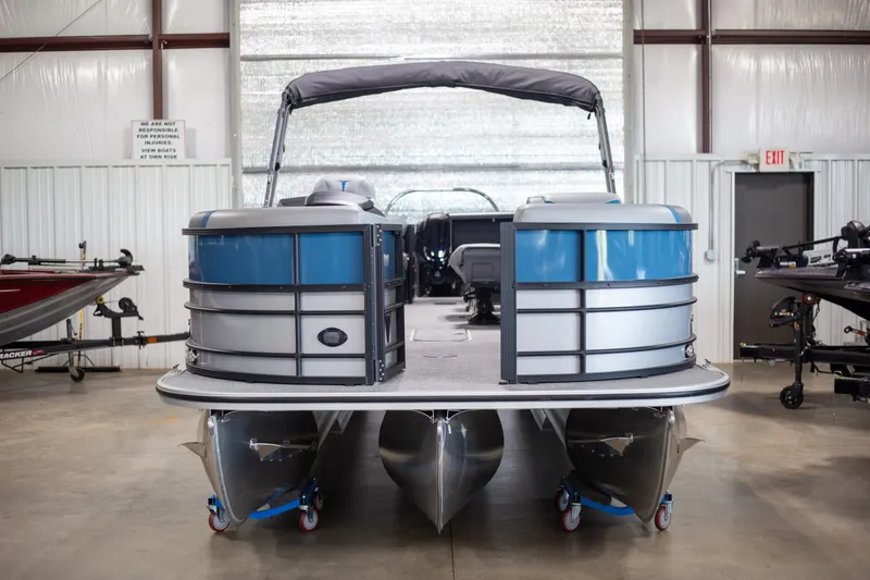 The Image of 2025 Trifecta 24E CS3 pontoon boat in a showroom setting. - 1