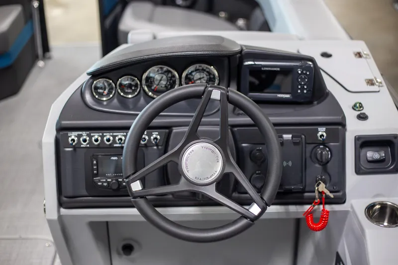 Slide: The Image of 2025 Trifecta 24E CS3 boat dashboard with steering wheel and control panel. - 10