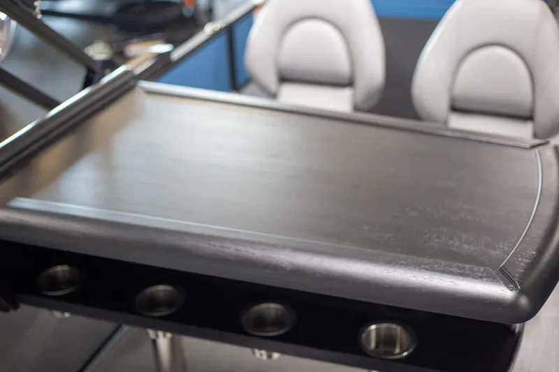 Slide: The Image of 2025 Trifecta 24E CS3 boat interior with sleek table and modern seating. - 12