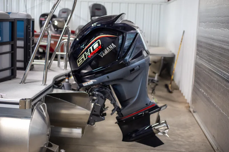 Slide: The Image of 2025 Trifecta 24E CS3 pontoon boat with Yamaha SHO outboard motor in a garage. - 5