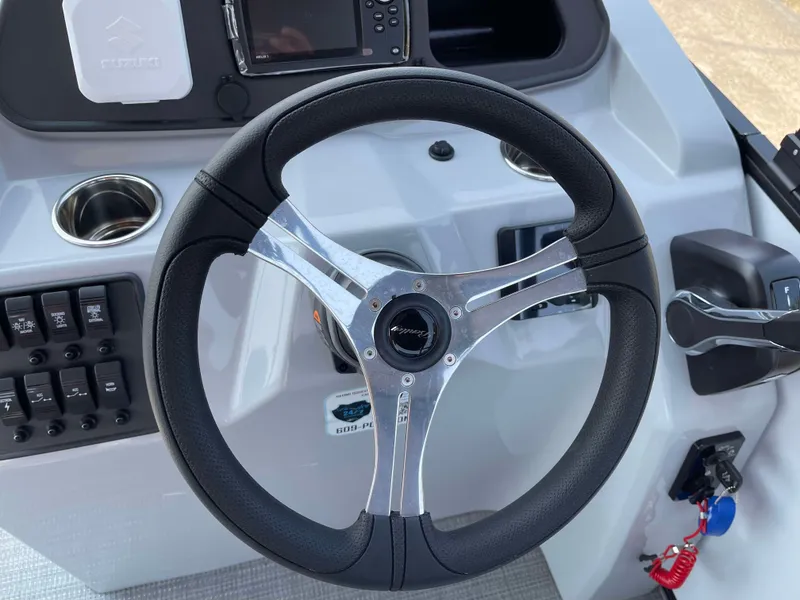 Slide: The Image of 2025 Bentley Pontoons Bolt 223 steering wheel and dashboard controls. - 14