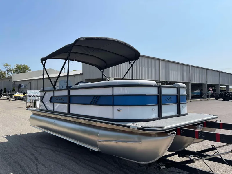 Slide: The Image of 2025 Bentley Pontoons Bolt 223 with canopy, parked outdoors. - 2