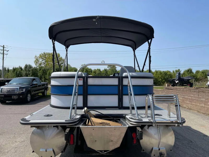 Slide: The Image of 2025 Bentley Pontoons Bolt 223 with canopy, rear view in outdoor setting. - 5