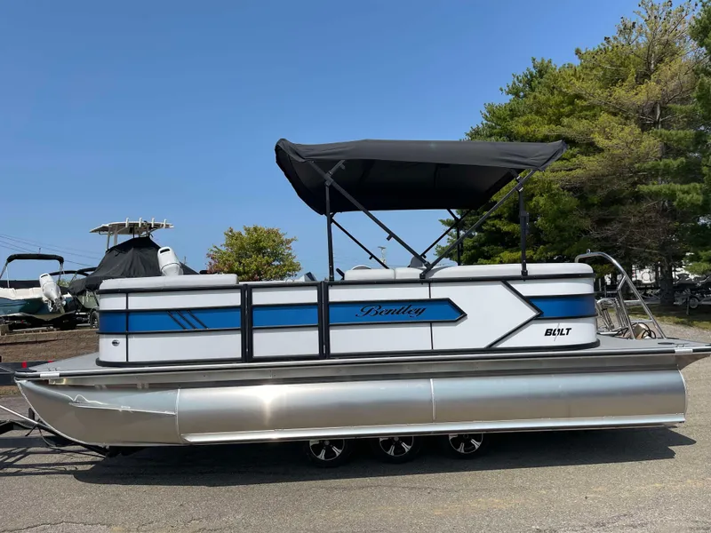 Slide: The Image of 2025 Bentley Pontoons Bolt 223 pontoon boat with blue accents and canopy. - 7