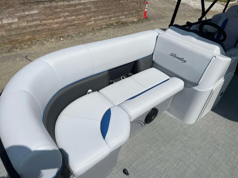 Slide: The Image of 2025 Bentley Pontoons Bolt 223 interior with white and blue seating. - 9