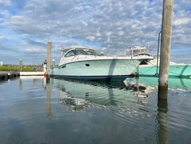 The Image of 2005 Tiara Yachts 4200 Open docked on calm water under a cloudy sky. - 0