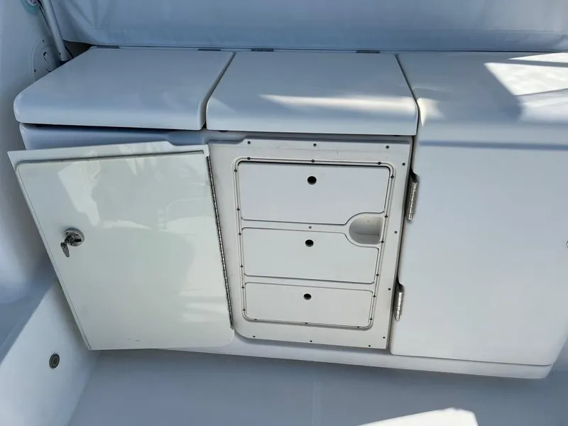 Slide: The Image of 2005 Tiara Yachts 4200 Open storage compartment with open door and drawers. - 11