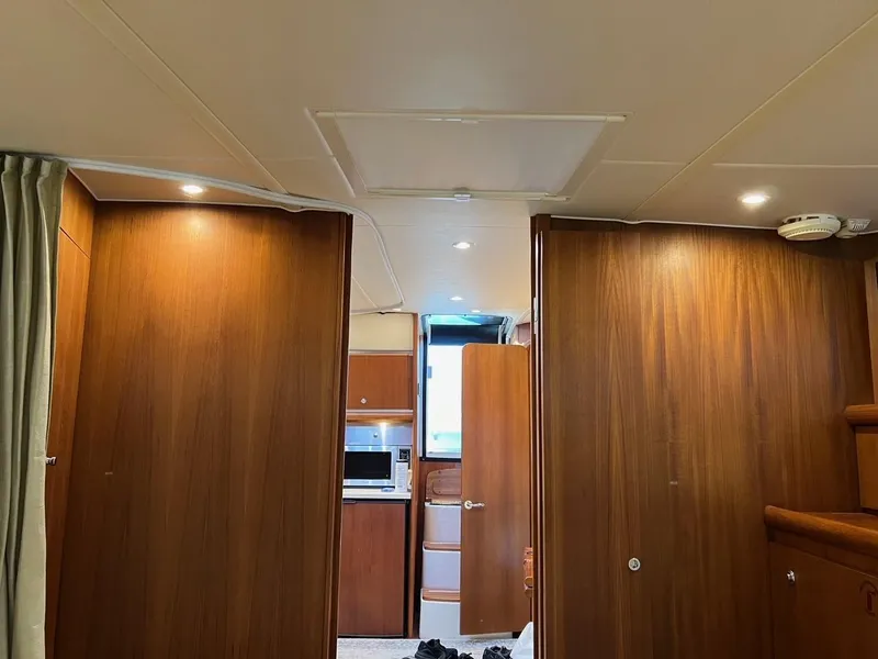 Slide: The Image of Interior of 2005 Tiara Yachts 4200 Open with wood paneling and modern lighting. - 12