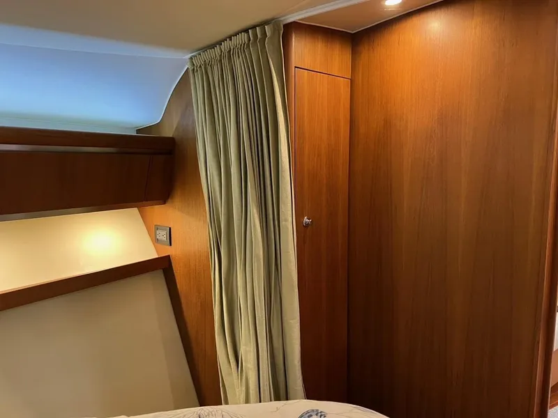Slide: The Image of Interior of 2005 Tiara Yachts 4200 Open with wood paneling and curtains. - 13
