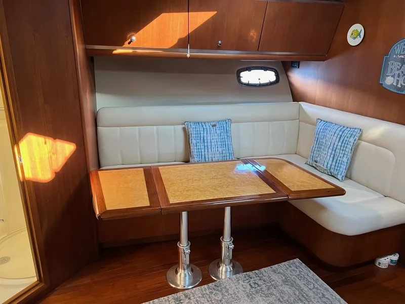 Slide: The Image of 2005 Tiara Yachts 4200 Open interior with cozy seating and wooden table. - 14