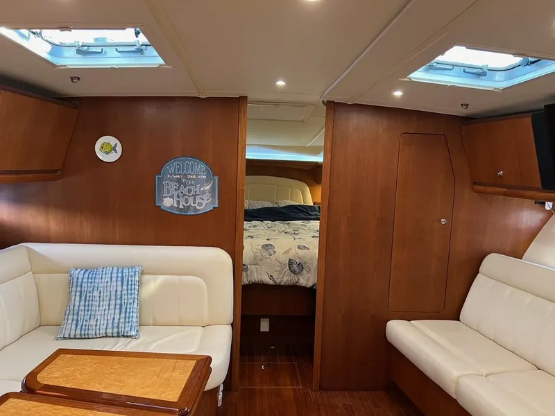 Slide: The Image of Interior of 2005 Tiara Yachts 4200 Open with cozy seating and wood accents. - 16