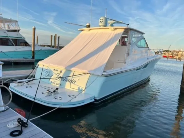 Slide: The Image of 2005 Tiara Yachts 4200 Open docked at marina, covered deck, calm waters. - 2