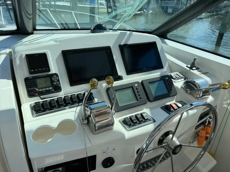 Slide: The Image of 2005 Tiara Yachts 4200 Open helm with advanced navigation controls and displays. - 7