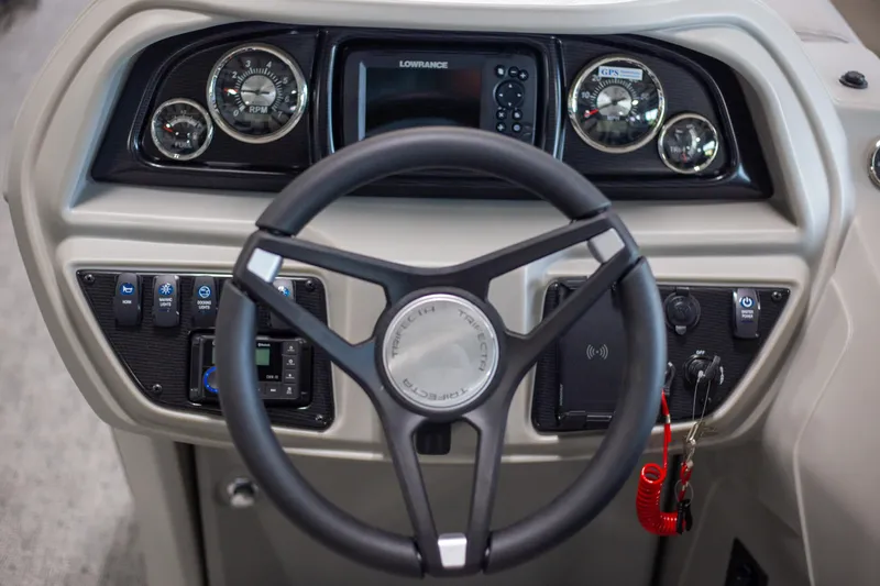 Slide: The Image of Trifecta 24TRFC LE 2025 boat dashboard with steering wheel and control panel. - 10