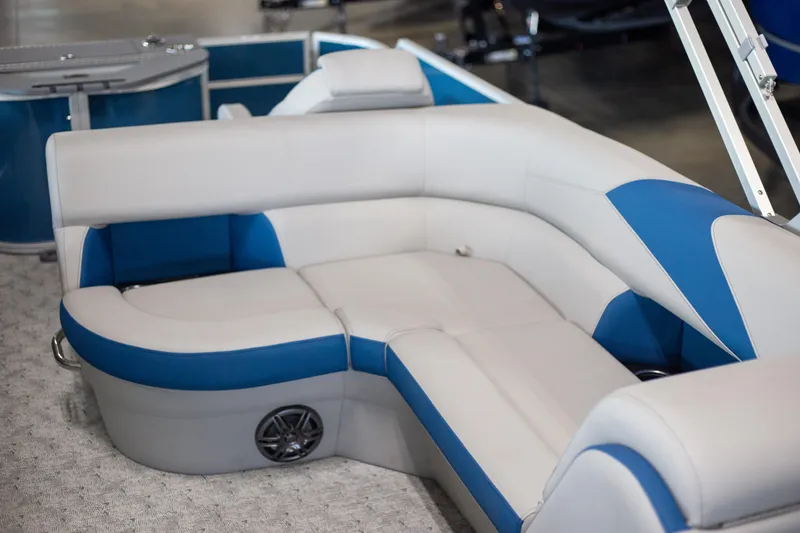 Slide: The Image of Luxurious seating on 2025 Trifecta 24TRFC LE pontoon boat with blue and white upholstery. - 5