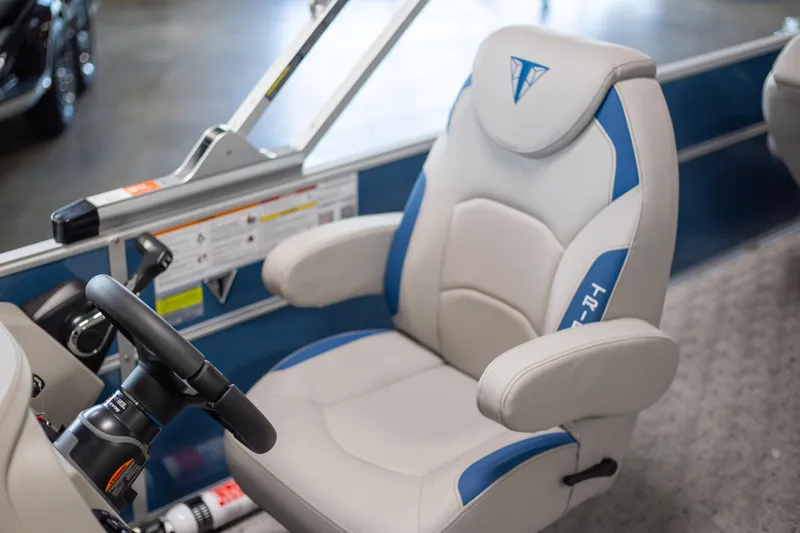 Slide: The Image of 2025 Trifecta 24TRFC LE boat captain's chair with blue accents and steering wheel. - 6