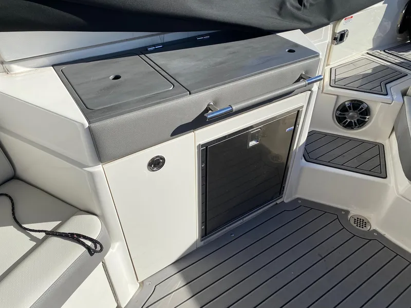 Slide: The Image of 2020 Sea Ray SLX 350 boat interior with sleek cabinetry and seating. - 12