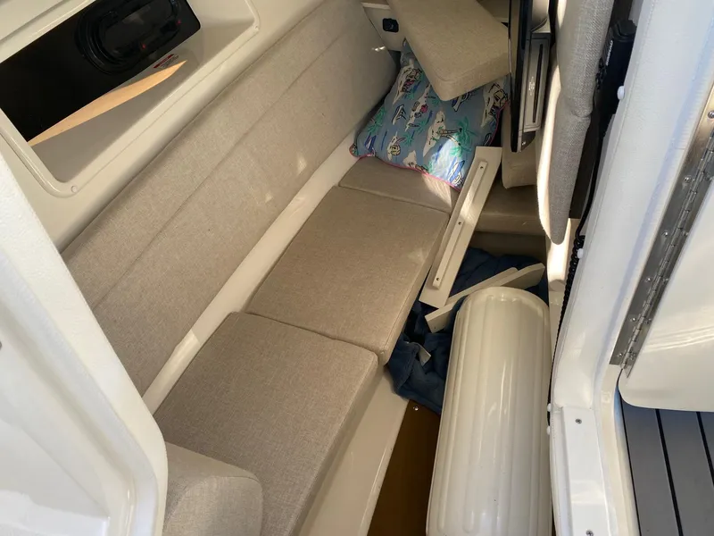 Slide: The Image of 2020 Sea Ray SLX 350 cabin interior with beige seating and nautical decor. - 14