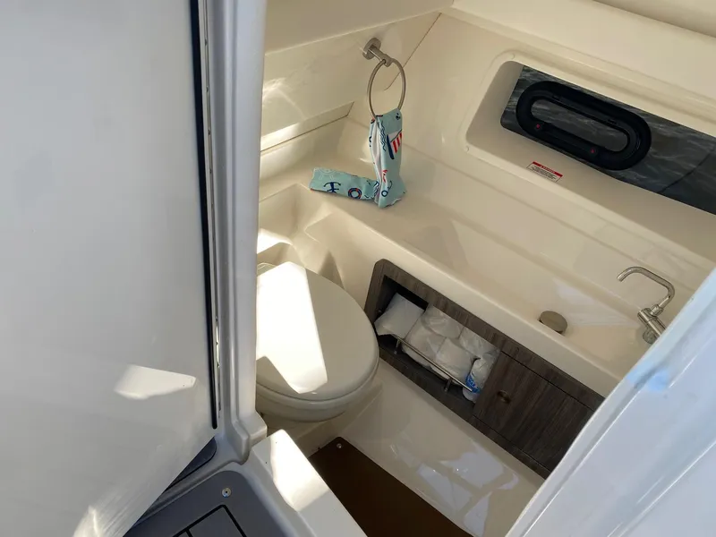 Slide: The Image of 2020 Sea Ray SLX 350 boat bathroom interior with toilet and sink. - 15