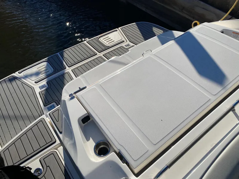 Slide: The Image of 2020 Sea Ray SLX 350 boat deck with non-slip surface, docked by the water. - 18