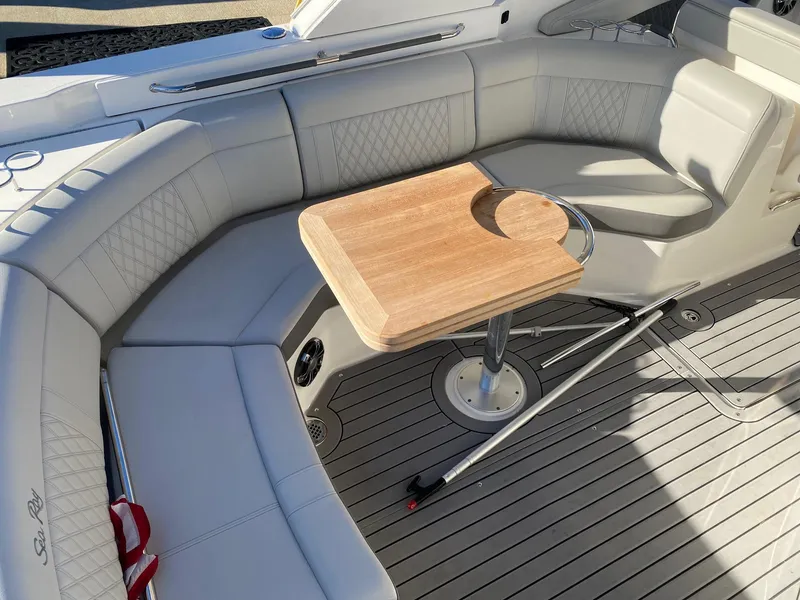 Slide: The Image of Luxurious seating area on 2020 Sea Ray SLX 350 boat with wooden table. - 6