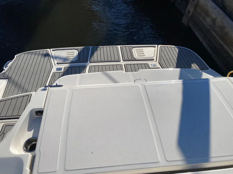 Slide: The Image of 2020 Sea Ray SLX 350 swim platform with textured surface and water backdrop. - 7