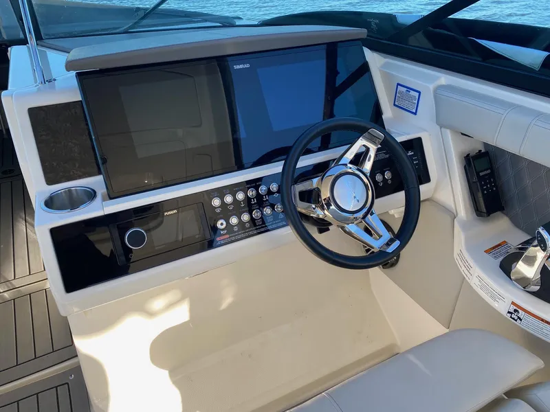 Slide: The Image of 2020 Sea Ray SLX 350 helm with modern controls and sleek steering wheel. - 8